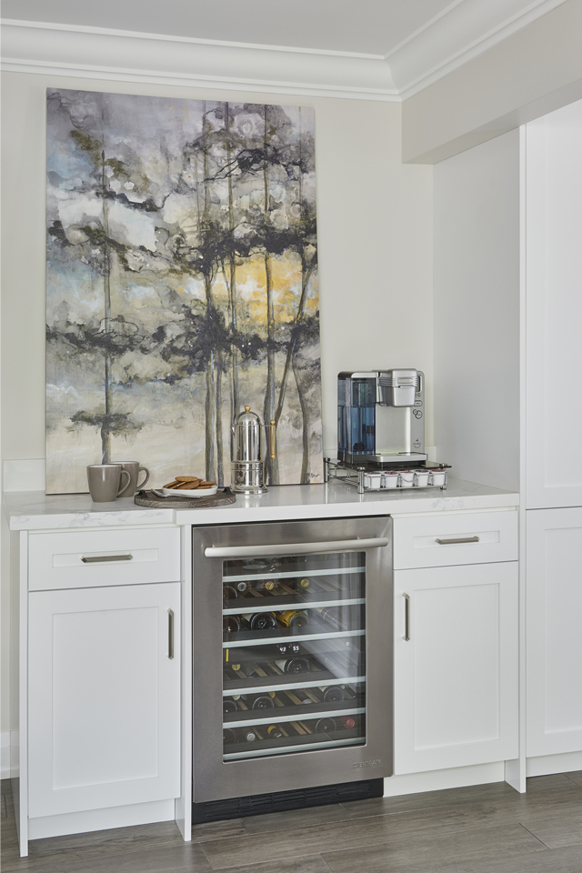 Built in nook in dining room with wine cooler and white cabinetry